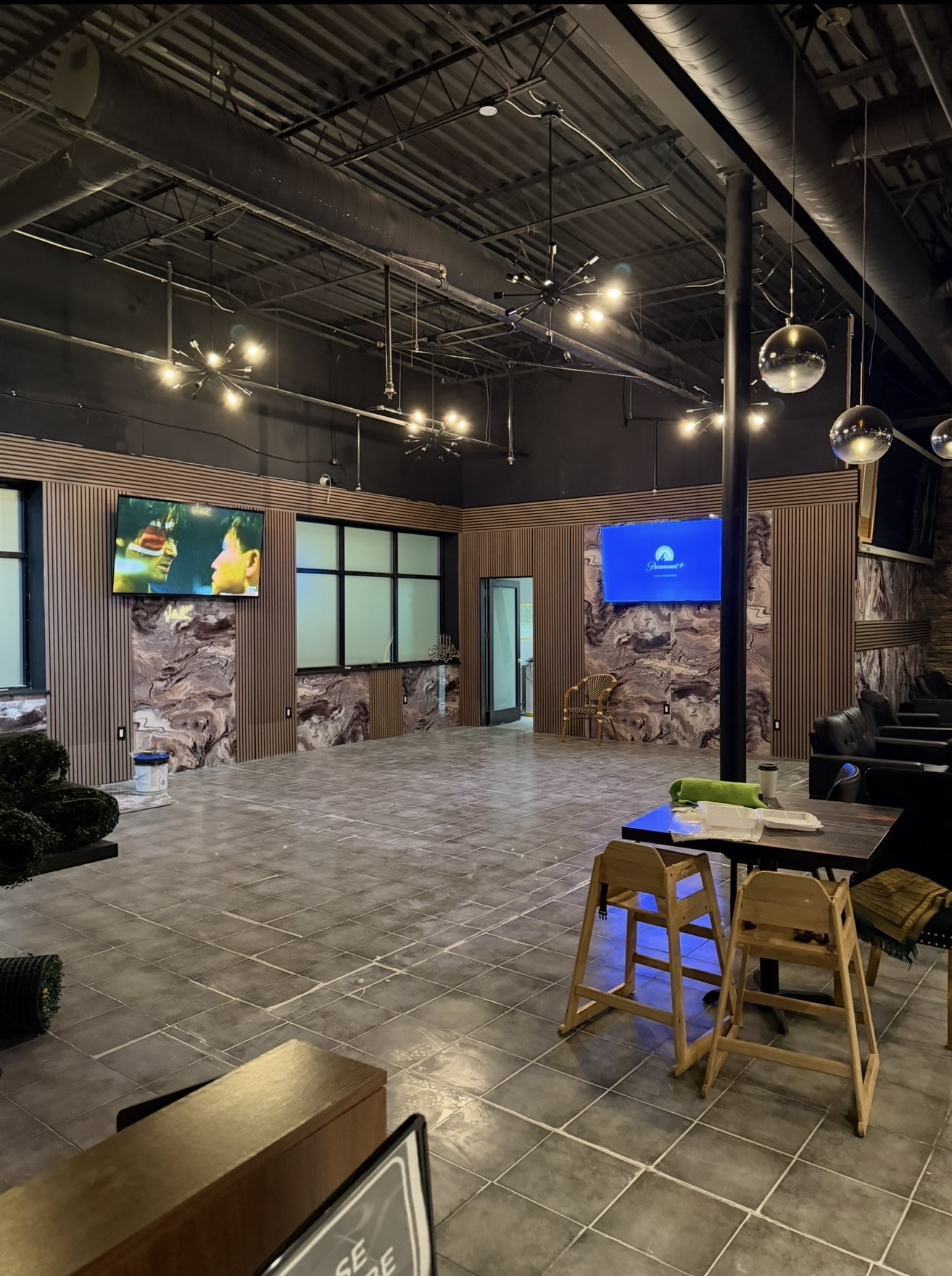 Completed commercial interior with finished wall panels, flooring, lighting, and seating